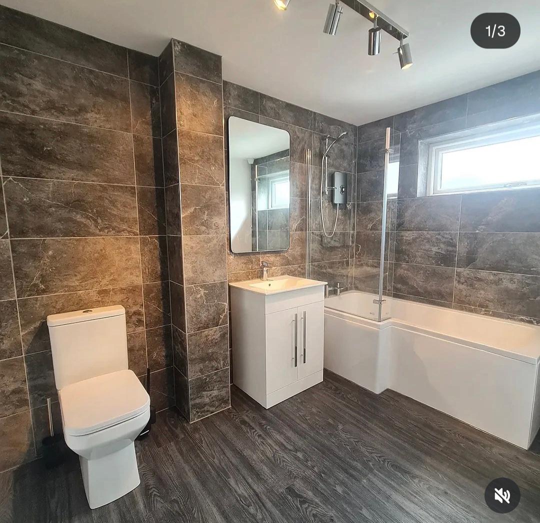 Contemporary bathroom with freestanding tub and large windows